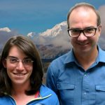 Lily and Bo smile at the camera in front of a mountain.
