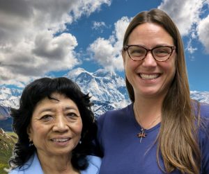 Elena and Jess smile in front of Denali.