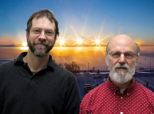 Scott and Terry smile in front of an Alaskan sunrise/sunset timelapse.
