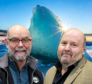 Fred and Kurt smile in front of a blue iceberg.