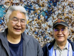 Orville and Justin, two older men with glasses, smile in front of a photoshopped background of kelp and clam beds.