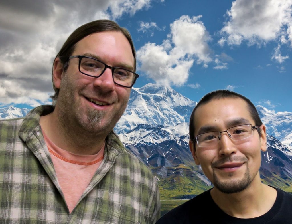 Victor and Ryan smile in front of a photoshopped background of Denali.