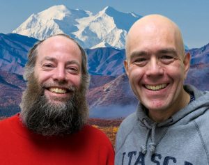 Jim and Eric smile in front of a Denali.