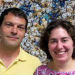 Shawn, a man with dark hair, and Emily, a woman with short hair and bright smile, in front of a patterned kelp background.
