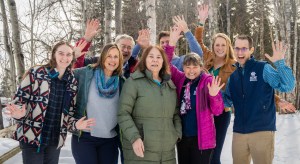 A group of 8 ACCAP researchers and staff smiling and waving at the camera.
